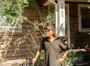 Kevin Fair stands in front of his home