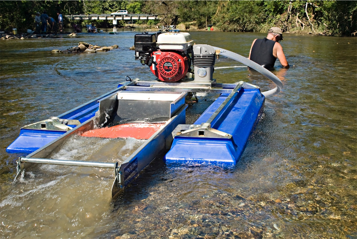 Suction dredge mining rig, extracting natural resources.