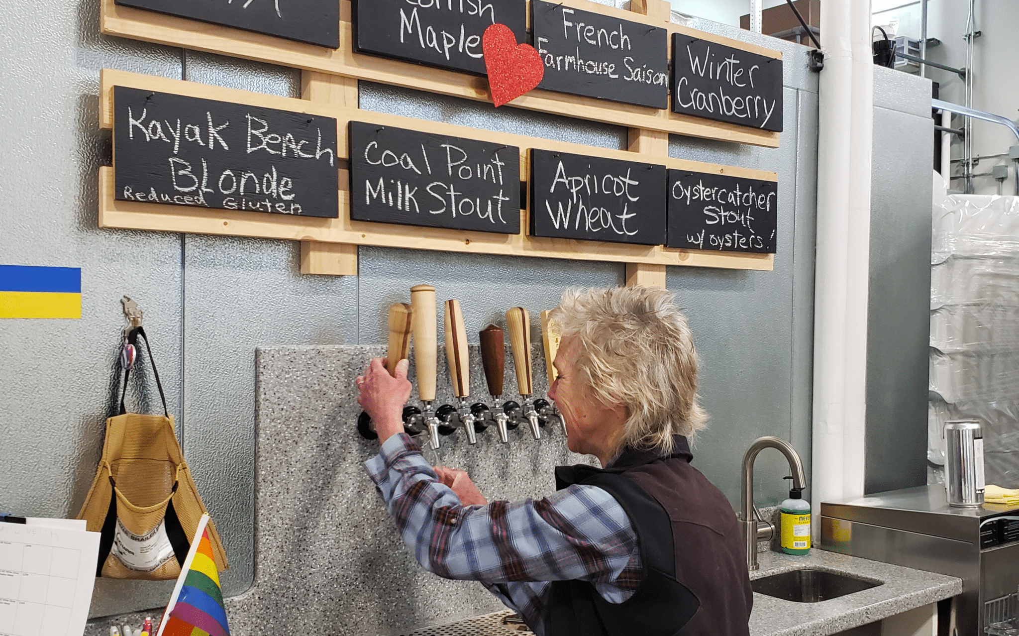 An image of Zip Kombucha with an employee pouring a drink.