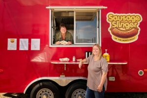 Heather Kratt and Holly Manzano with their food truck, Sausage Slingers of the Midwest. Photography Credit: Rick Wenner.
