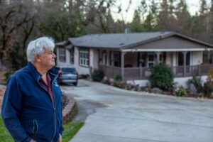 An image of PLF client George Sheetz standing outside of his home.